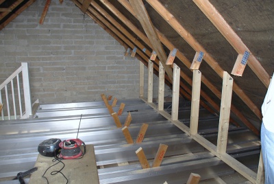 TeleBeams and stud walls in place with existing braces being cut out