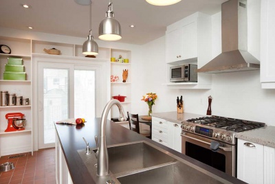 contemporary white kitchen with stainless steel and pendant lights
